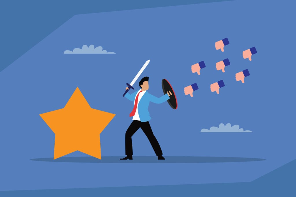 A businessman holding a sword and shield, defending against negative feedback and thumbs-down icons to protect a golden star, symbolizing quality and positive reputation