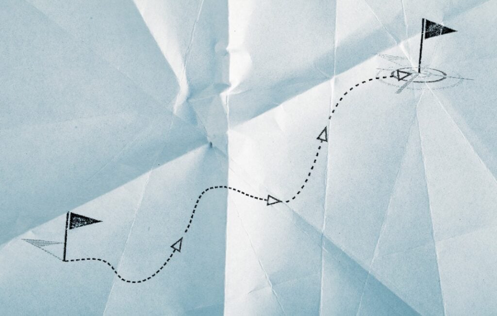 Drawing of path between flags on crumpled paper