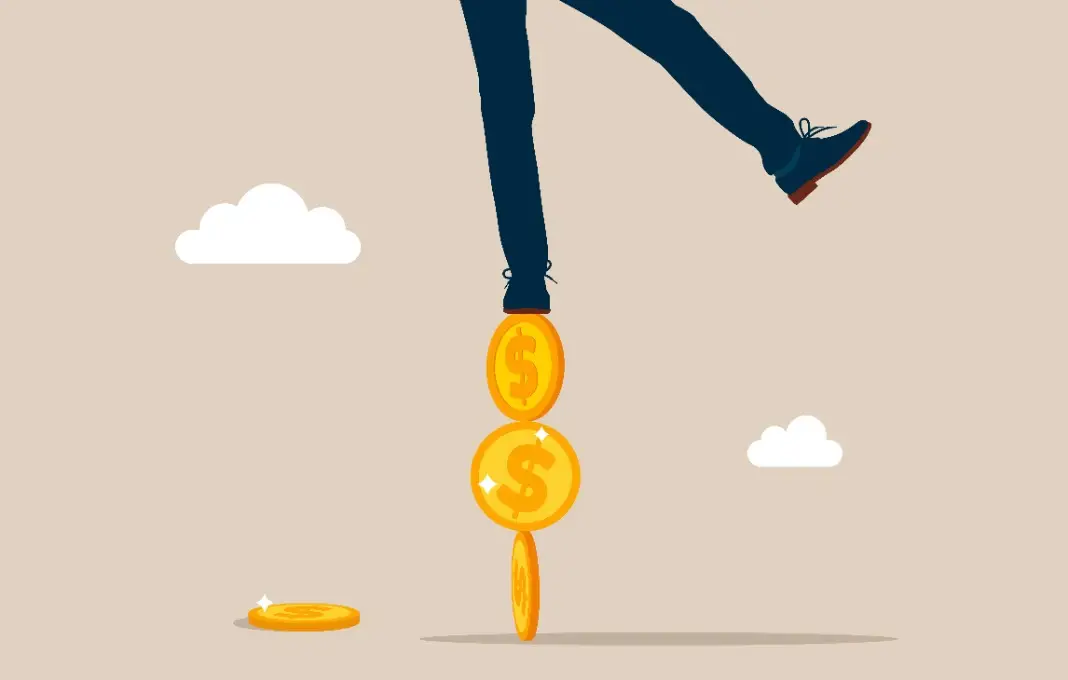 Business man balancing on coins