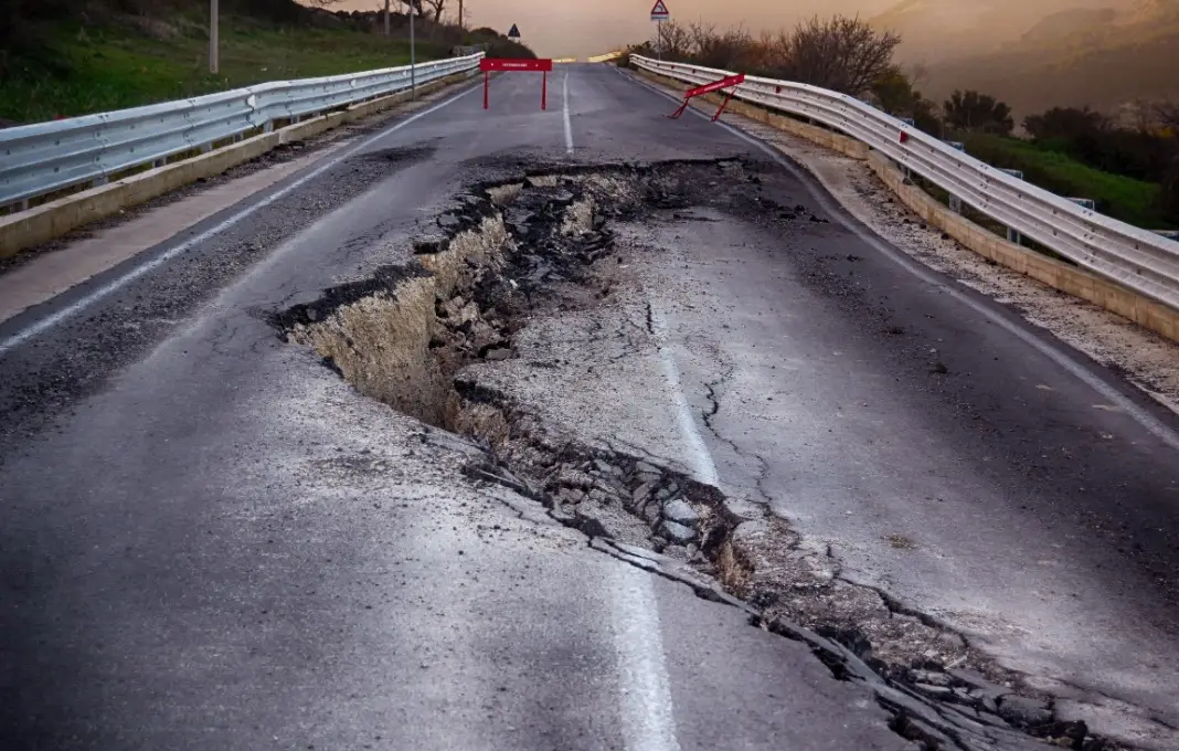 Asphalt road destroyed by the landslide