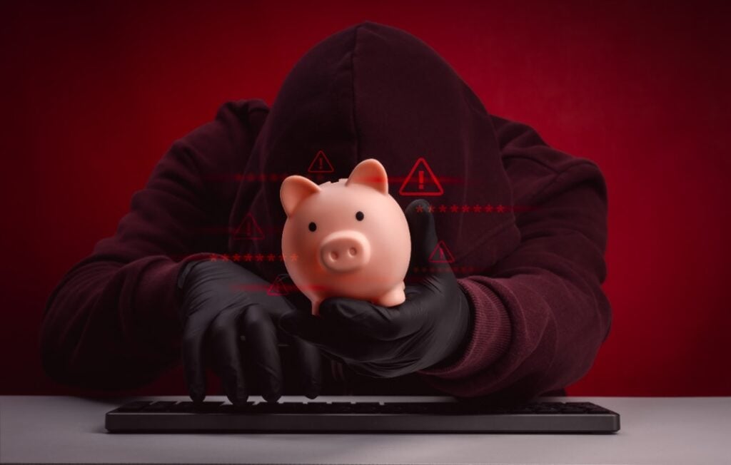 Financial hacking concept with masked hacker stealing piggy bank and warning symbols.