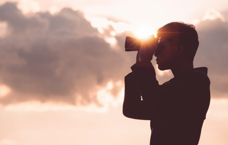 Man looking through binoculars