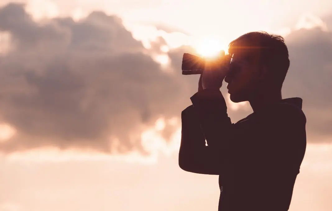Man looking through binoculars