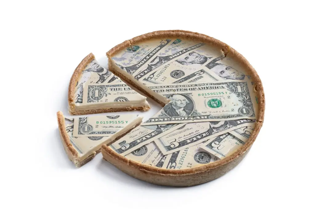 Pie filled with dollars being sliced up